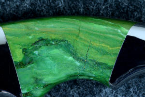 "Raptor" obverse side gemstone handle scale detail, 6 power enlargement showing complex inclusions of fuchsite mica and chalcedony in rare Budstone (Verdite) "Raptor" obverse side gemstone handle scale detail, 6 power enlargement showing complex inclusions of fuchsite mica and chalcedony in rare Budstone (Verdite)