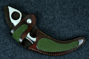 "Raptor" sheathed view. Sheath is deep and protective for radically curved knife blade and handle, and is inlaid with green rayskin, tough and durable "Raptor" sheathed view. Sheath is deep and protective for radically curved knife blade and handle, and is inlaid with green rayskin, tough and durable