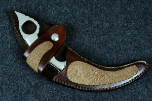 "Raptor" fine handmade custom karambit, sheathed view in tan rayskin inlaid in 9-10 oz. leather shoulder, stainless steel snap and heavy nylon stitching "Raptor" fine handmade custom karambit, sheathed view in tan rayskin inlaid in 9-10 oz. leather shoulder, stainless steel snap and heavy nylon stitching