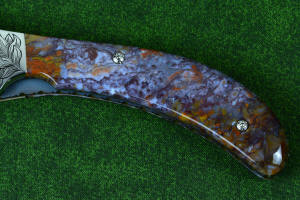 "Starling" obverse side gemstone handle detail in Rio Grande Agate with hand-engraved fasteners "Starling" obverse side gemstone handle detail in Rio Grande Agate with hand-engraved fasteners