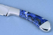 Sodalite gemstone on a chef's knife